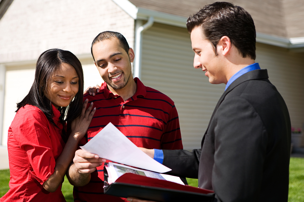 real estate agent showing papers